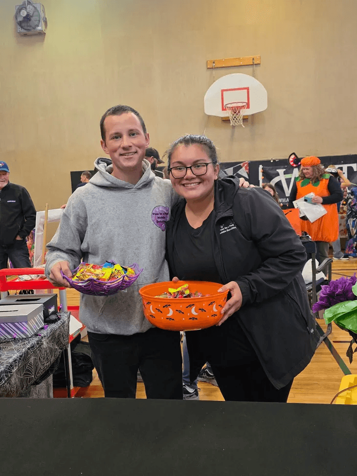 trevor and isabela giving out halloween candy